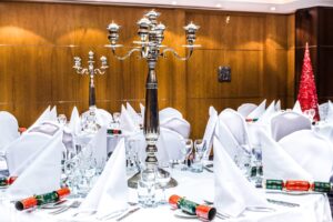 Christmas dining rooms with crackers and candelabras.